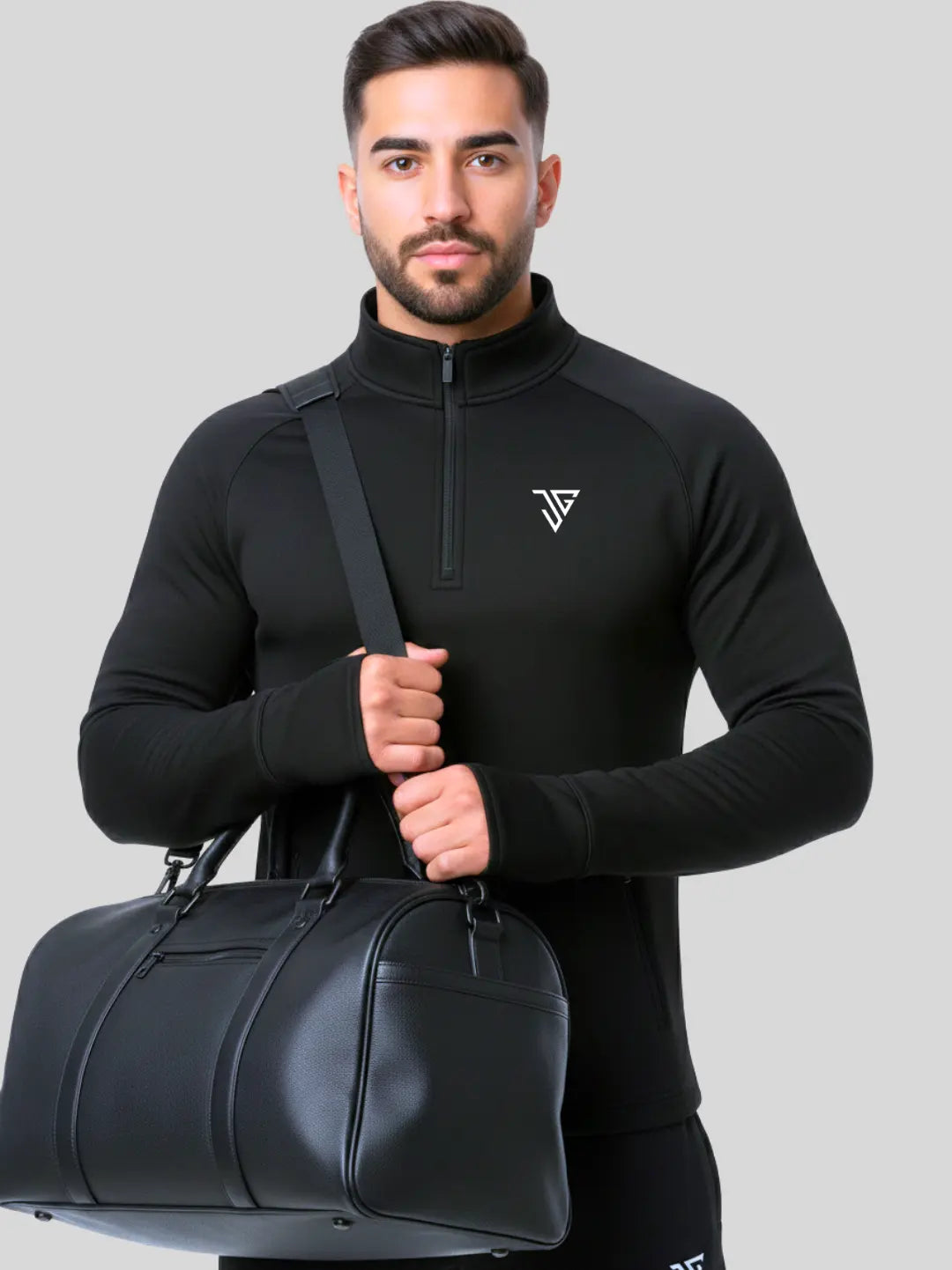 Man wearing black Flex Pullover by JYGMA holding a duffle bag
