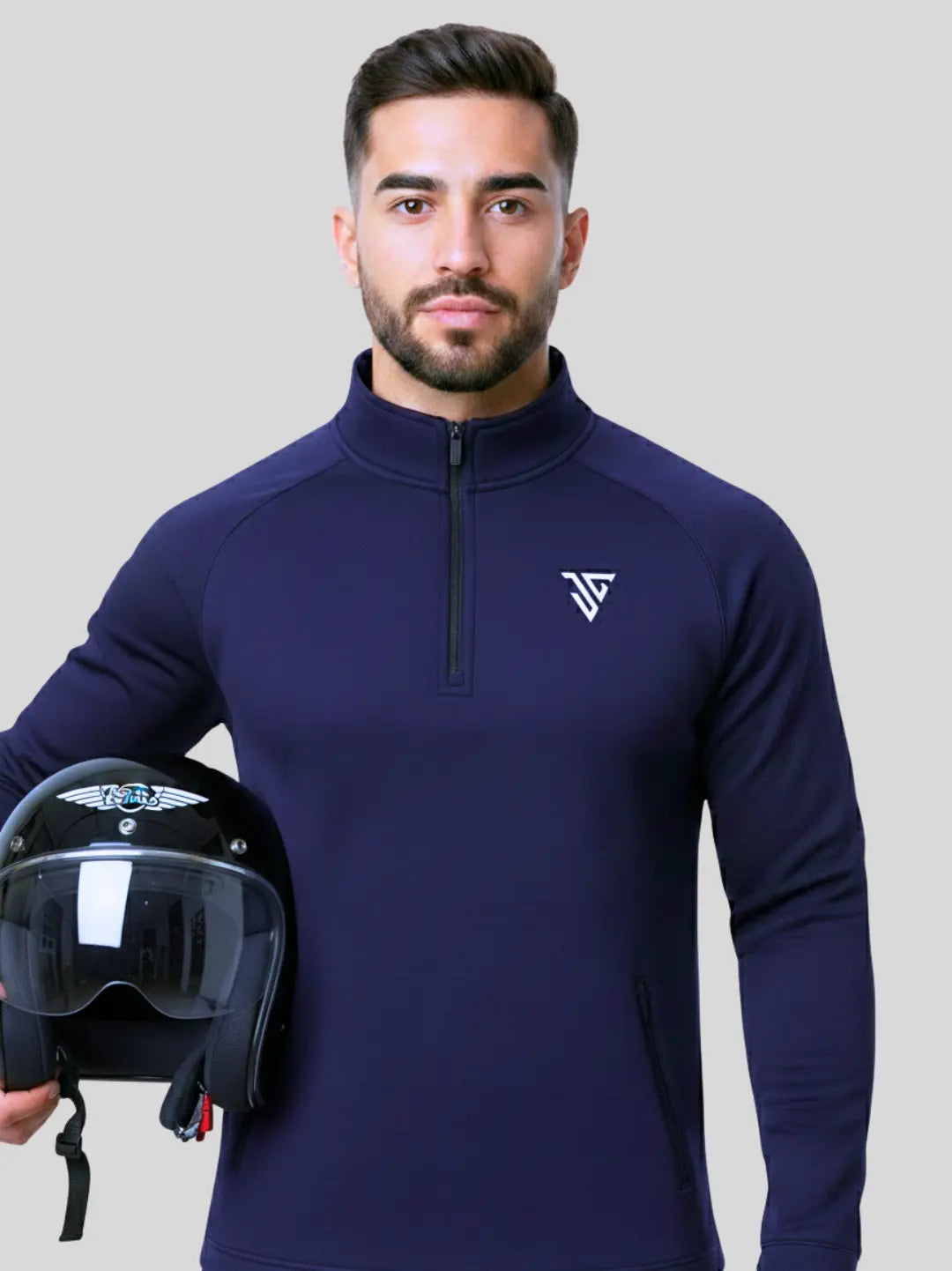 Man wearing navy Flex Pullover by JYGMA holding a helmet