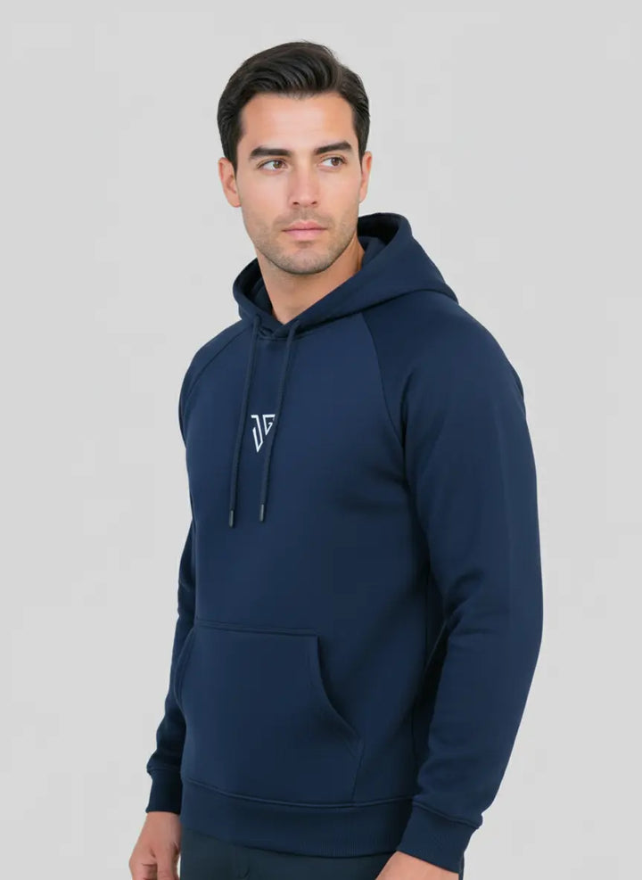 Man wearing navy blue Pride Hoodie by JYGMA in a front pose
